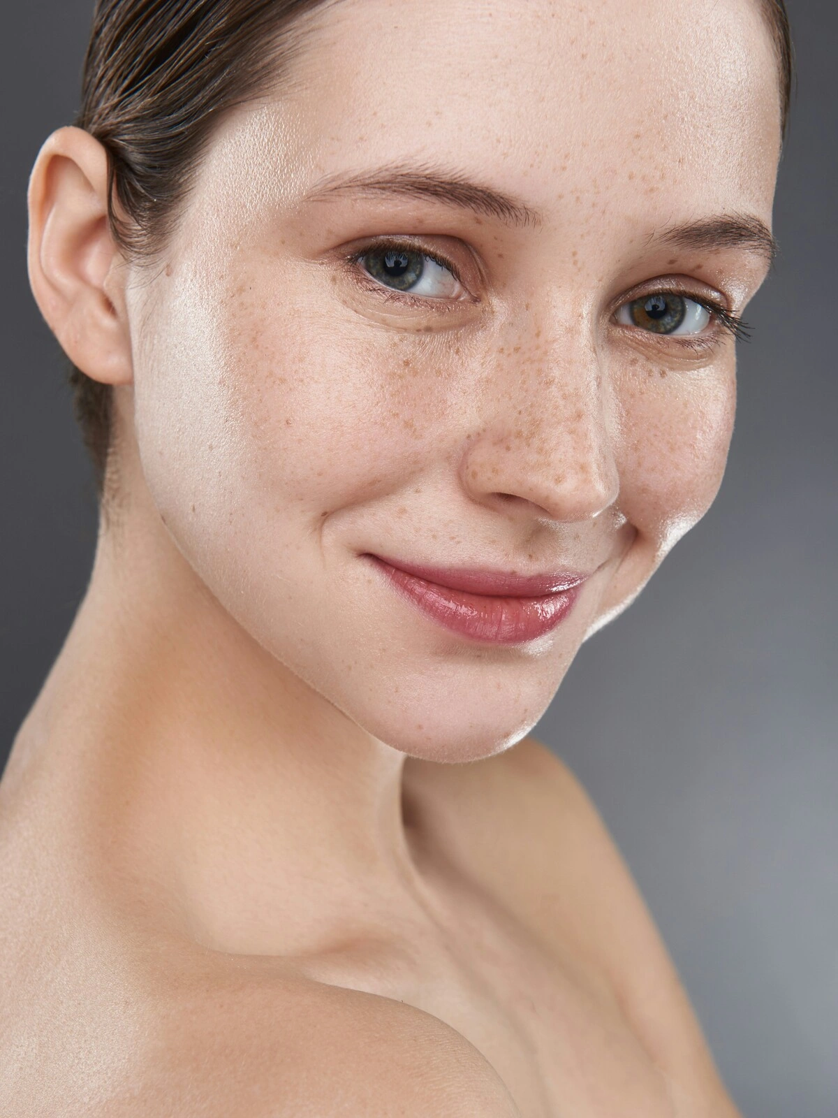 Close-up of a woman’s makeup-free face showing soft peach fuzz